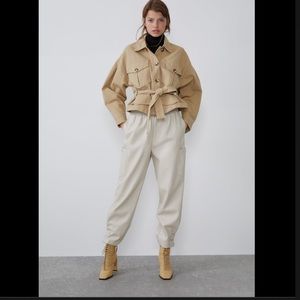 NWT cream faux leather cargo pants. elastic waist & silver button details.